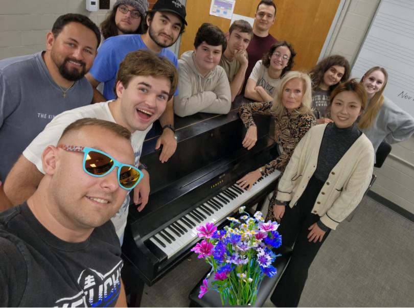 photo of students around piano