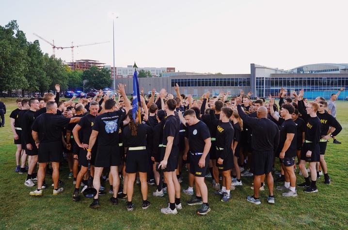 photo of cadets raising arms in a huddle